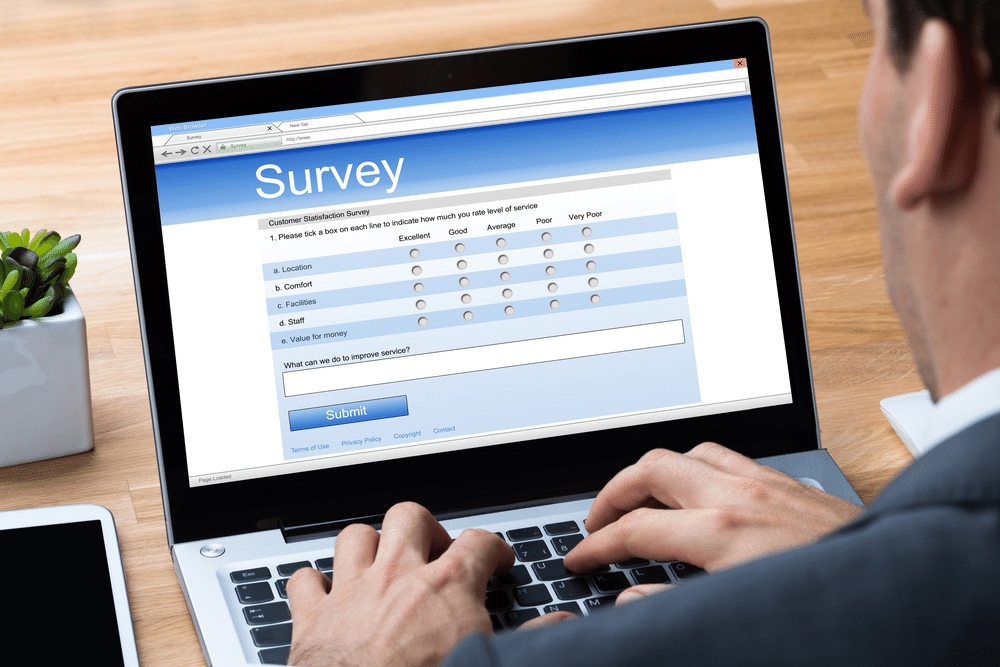 Guy creating a survey within his customer experience management platform