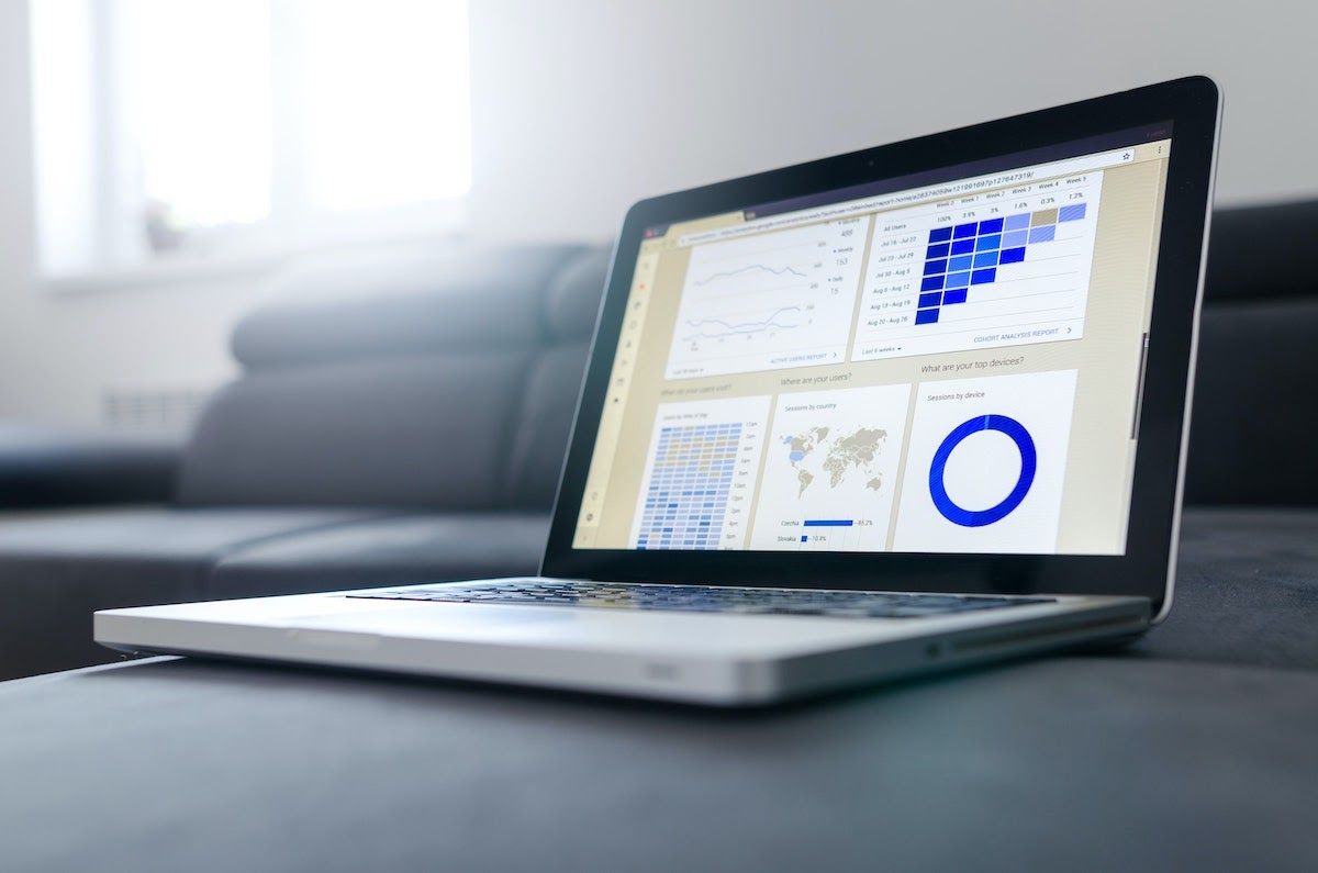 A laptop displaying data and graphs on a data visualization tool.