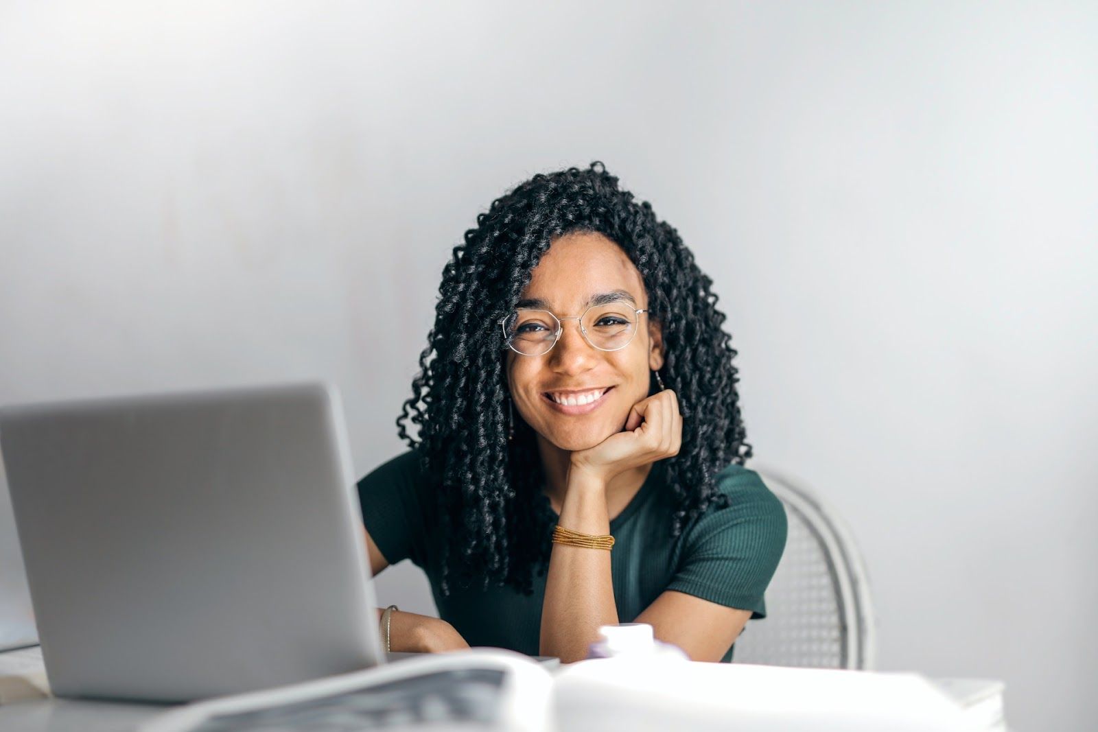 Person working with a laptop creating online surveys with a Qualtrics competitor.