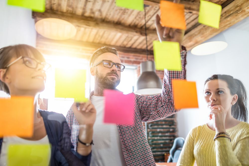 A team planning out a project using post-it notes