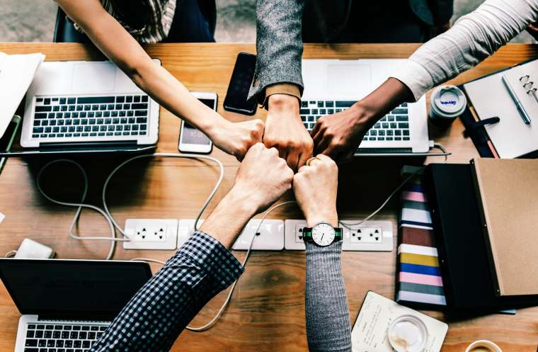 A team fist-bumping each other