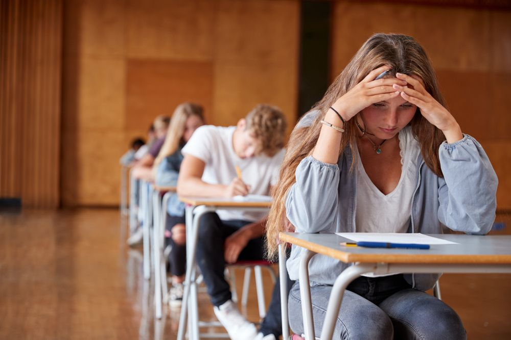 Students working at their desks in a classroom.