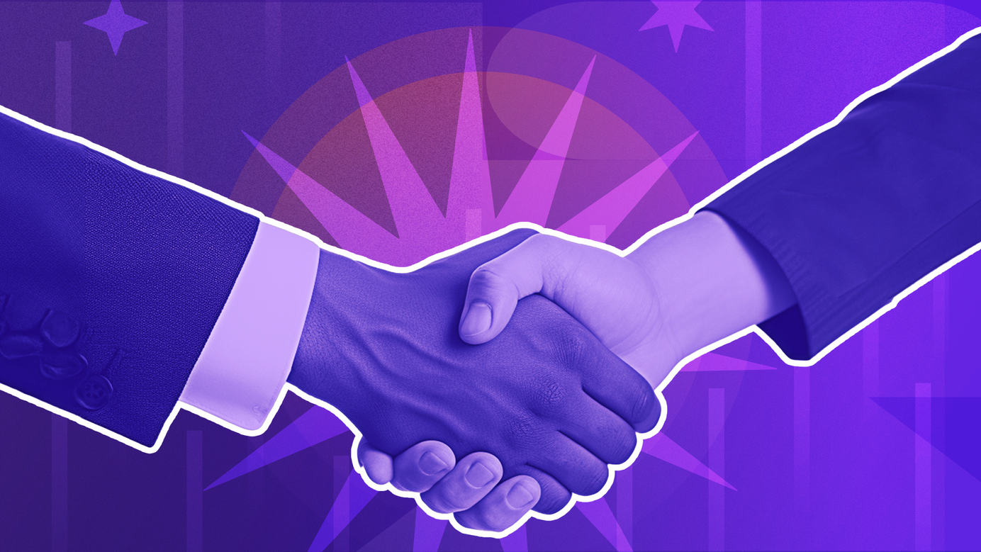 Two businessmen are shaking hands in agreement and understanding.